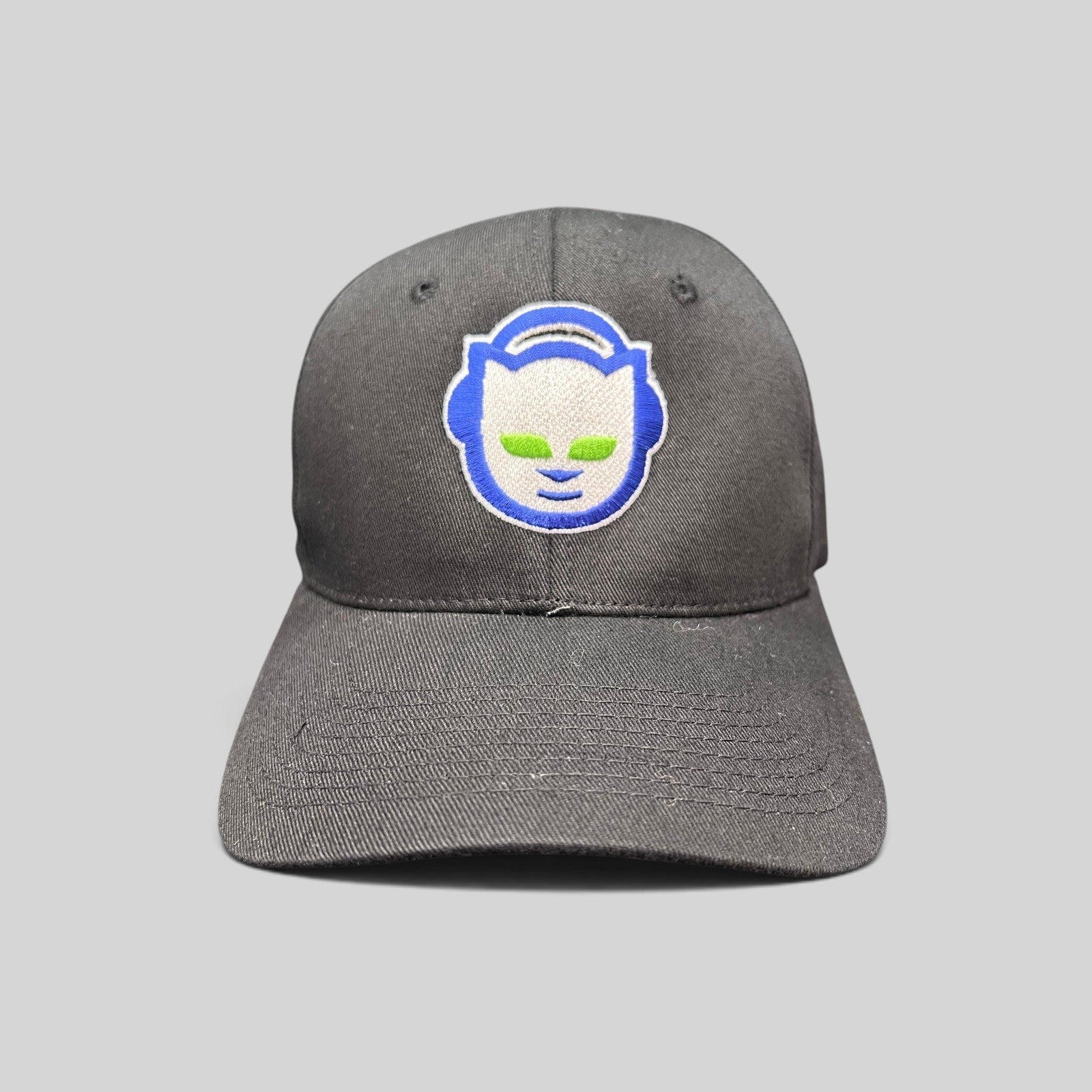 Raree Finds vintage Y2K black flex hat featuring an embroidered blue and green Napster cat logo on the front