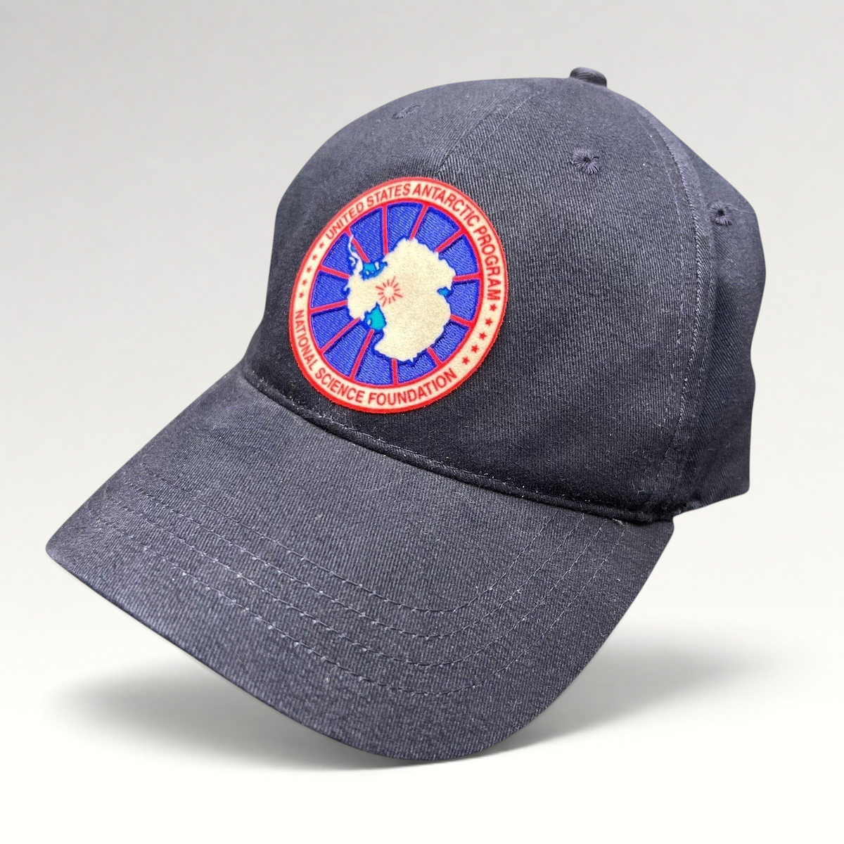 Raree Finds navy cotton strapback hat featuring a United States Antarctic Program and NSF embroidered patch