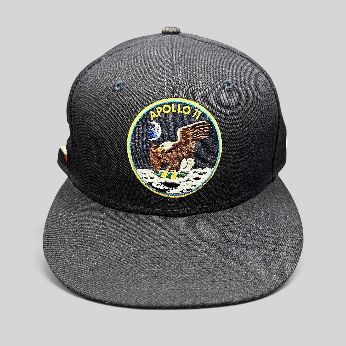 Raree Finds navy blue New Era 59FIFTY fitted hat featuring an embroidered Apollo 11 moon mission patch on the front.