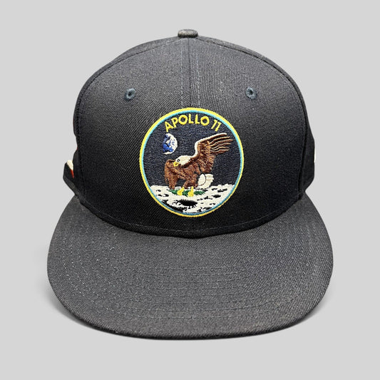 Raree Finds navy blue New Era 59FIFTY fitted hat featuring an embroidered Apollo 11 moon mission patch on the front.