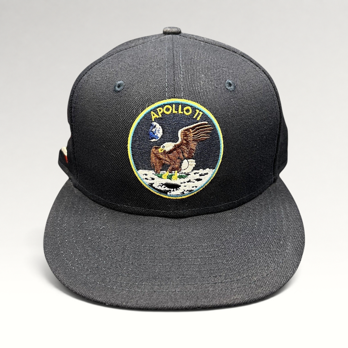 Raree Finds navy blue New Era 59FIFTY fitted hat featuring an embroidered Apollo 11 moon mission patch on the front.