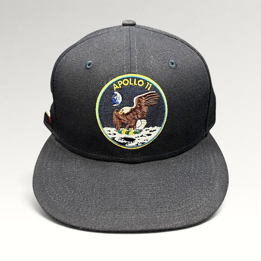 Raree Finds navy blue New Era 59FIFTY fitted hat featuring an embroidered Apollo 11 moon mission patch on the front.
