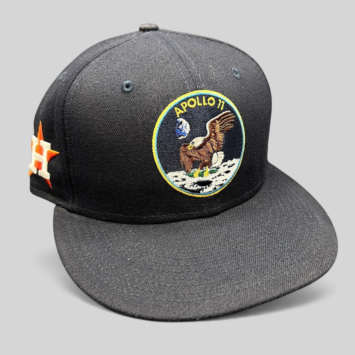 Raree Finds navy blue New Era 59FIFTY fitted hat featuring an embroidered Apollo 11 mission patch on the front.