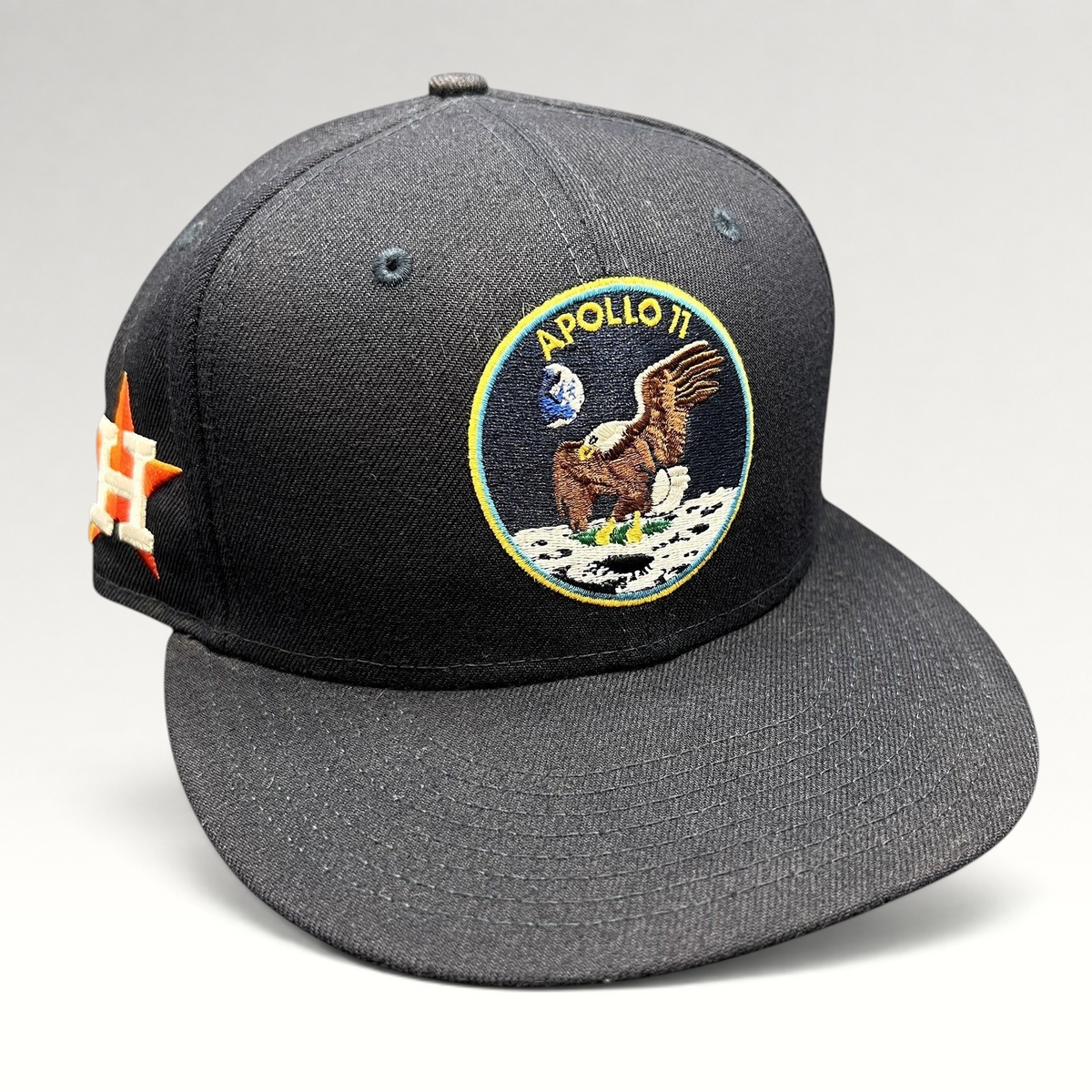 Raree Finds navy blue New Era 59FIFTY fitted hat featuring an embroidered Apollo 11 mission patch on the front.