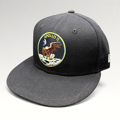 Raree Finds navy blue New Era 59FIFTY fitted hat featuring an embroidered Apollo 11 mission patch on the front.