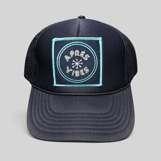Raree Finds navy blue trucker hat with an Après Vibes embroidered patch, mesh back, and adjustable snapback closure.