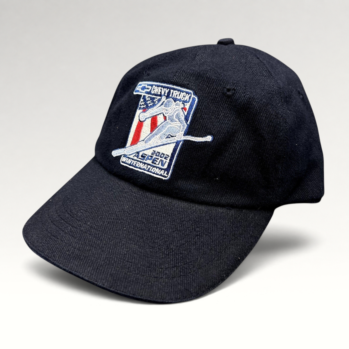 Raree Finds navy blue 2002 Aspen Winternational cotton strapback hat with Chevy Truck and alpine skier embroidery.
