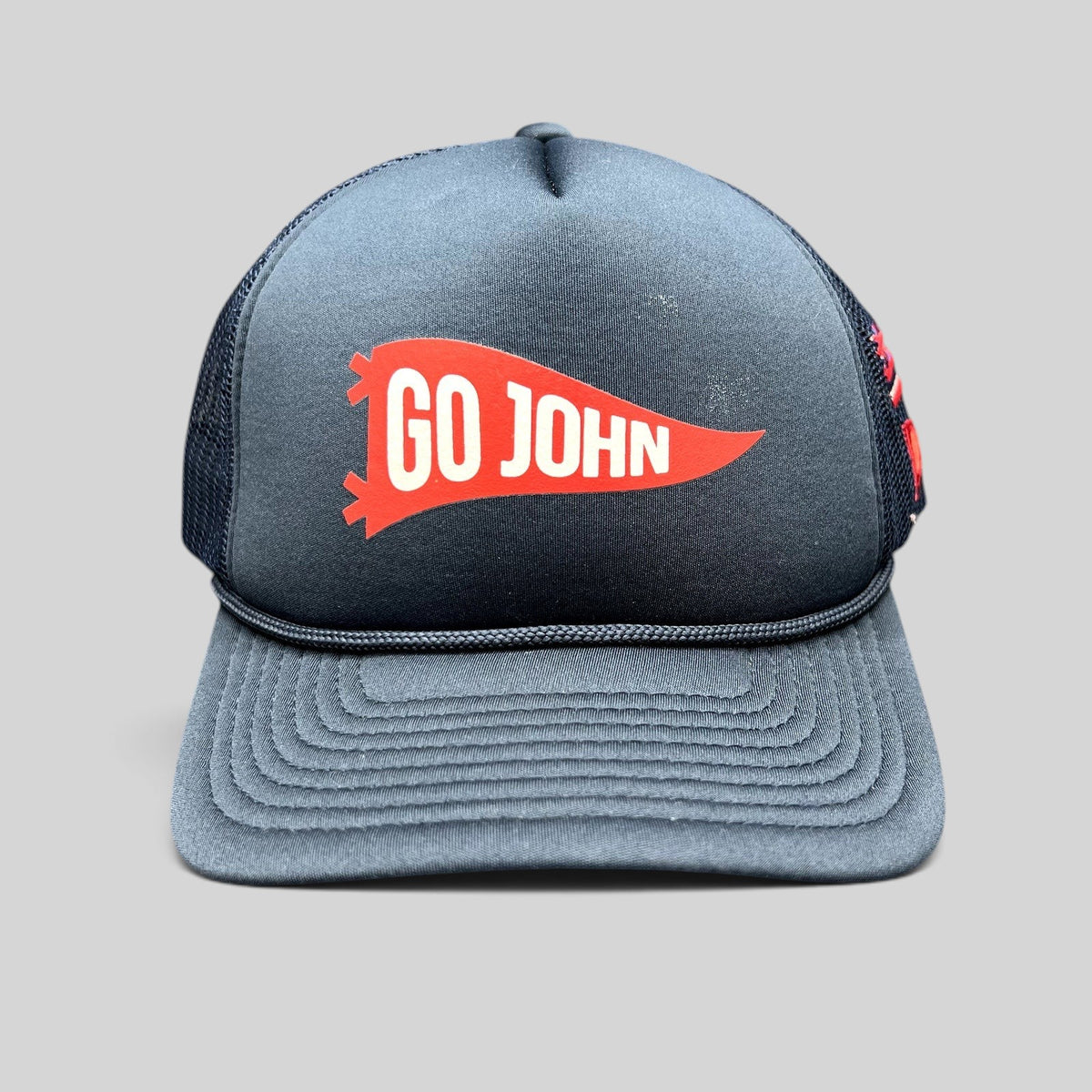 Raree Finds navy blue vintage-style trucker hat with a red Go John pennant graphic and braided rope brim detail.