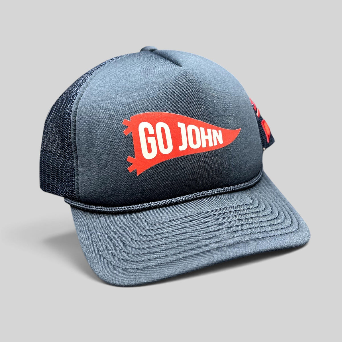 Raree Finds navy blue vintage trucker hat with red GO JOHN pennant graphic, braided rope, and mesh back panels.