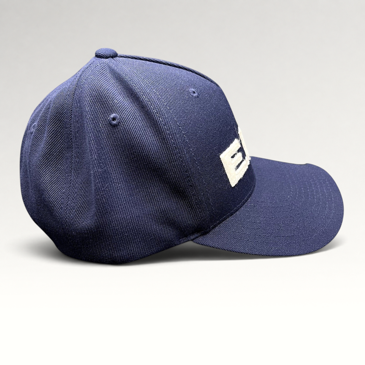 Raree Finds navy blue Yupoong Classics snapback hat with white felt E.N.D. lettering on a structured crown
