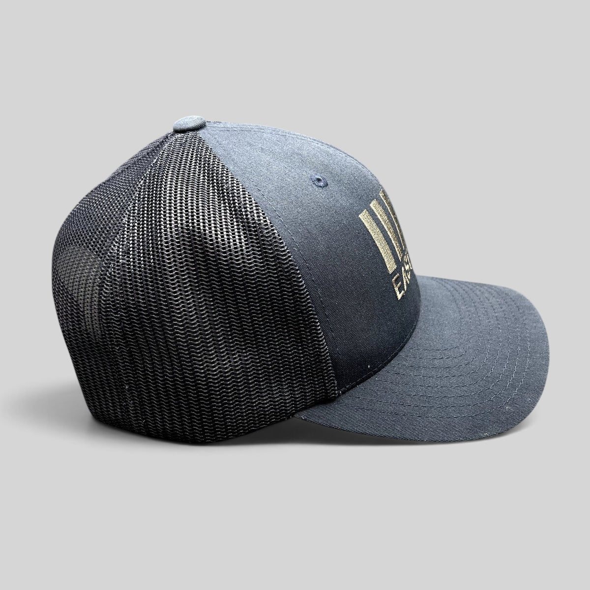 Raree Finds navy blue East End Studios trucker snapback hat with mesh back and embroidered logo, side view
