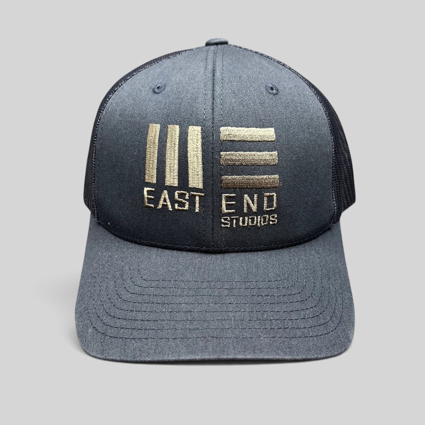 Raree Finds navy blue East End Studios trucker snapback hat with embroidered gold logo and breathable mesh back