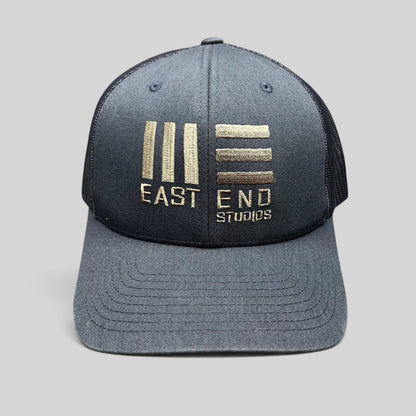 Raree Finds navy blue East End Studios trucker snapback hat with embroidered gold logo and breathable mesh back