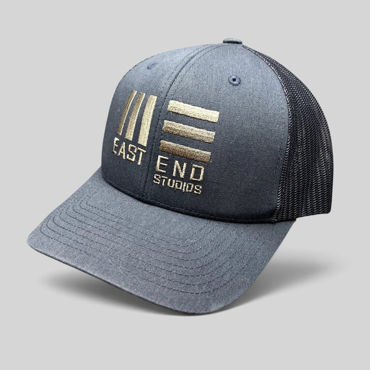 Raree Finds navy blue East End Studios trucker snapback hat with embroidered logo and breathable mesh back panels.