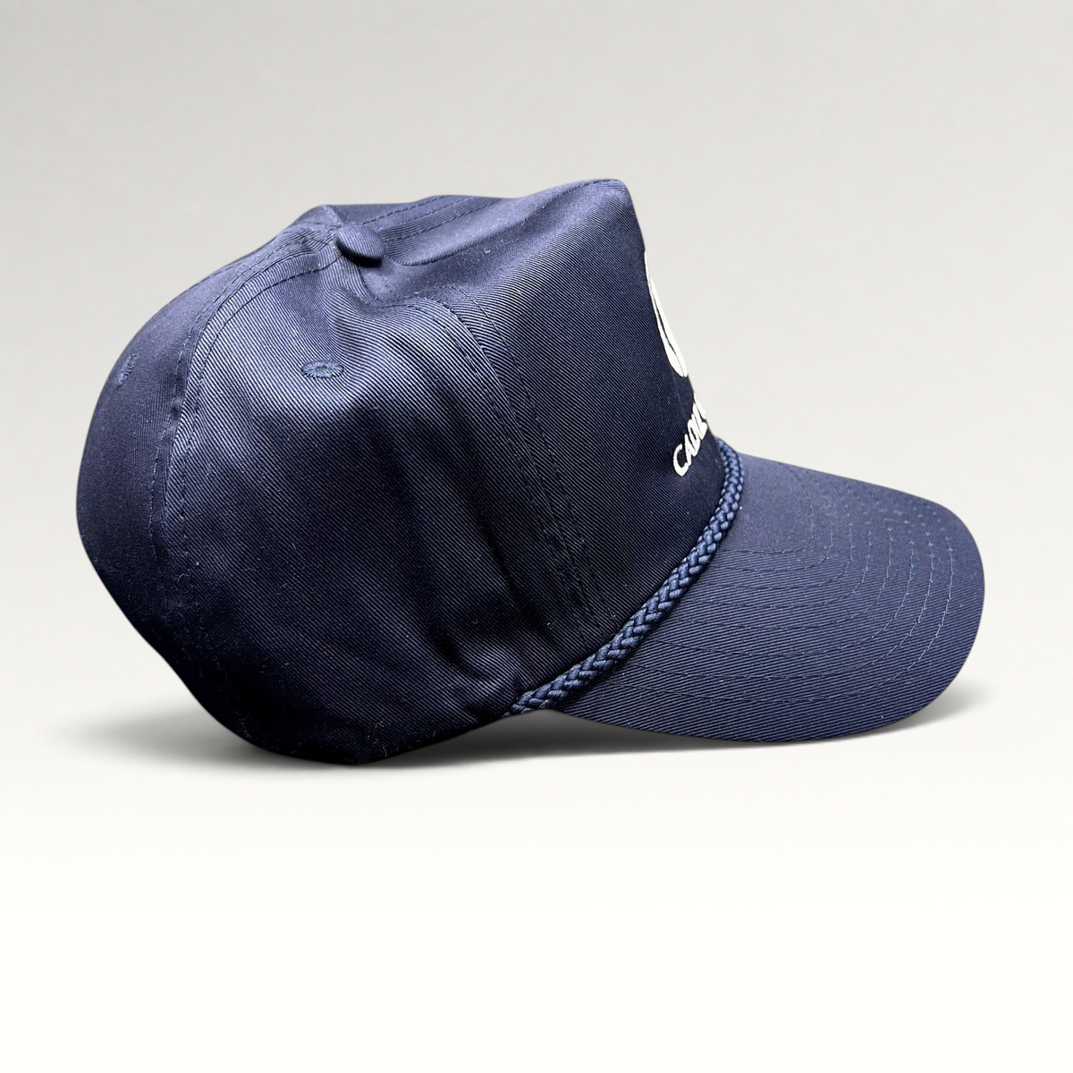 Raree Finds vintage navy blue Cadiz & Lluis snapback hat by Nissin Cap with white embroidery and braided rope detail.