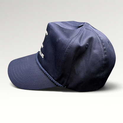 Raree Finds navy blue Cadiz & Lluis promotional snapback hat with white embroidered logo and braided rope bill detail.