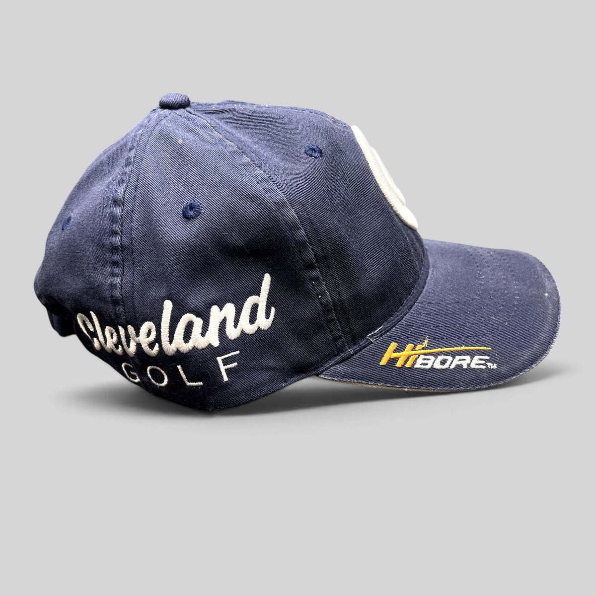 Raree Finds navy blue Cleveland Golf cotton twill strapback hat with side script embroidery and HiBore brim logo
