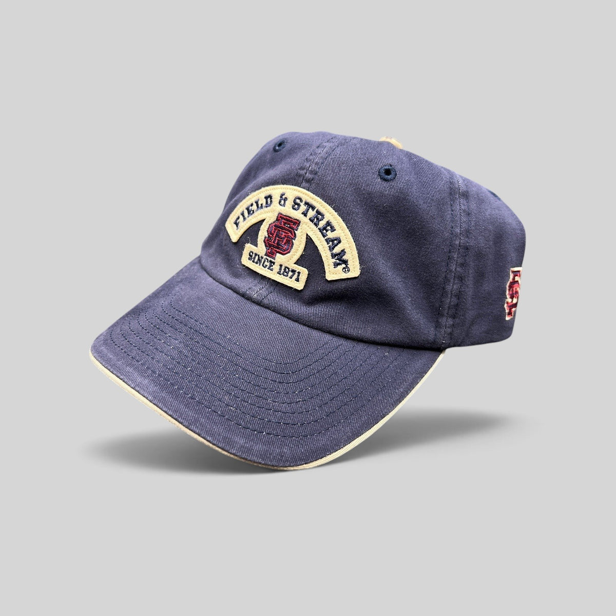 Raree Finds navy blue cotton baseball cap with Field & Stream Since 1871 embroidered patch and cream brim trim