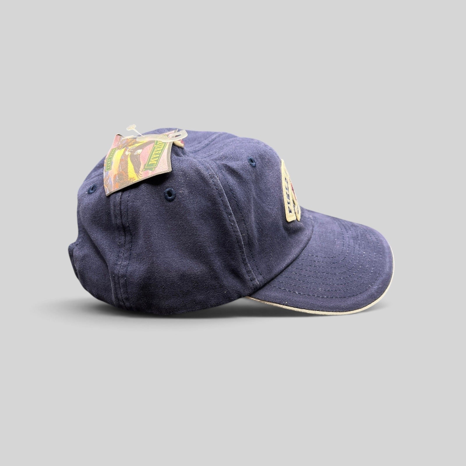 Raree Finds vintage navy blue cotton baseball cap with Field & Stream embroidered patch and cream brim trim.
