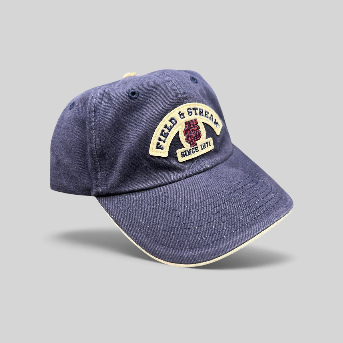 Raree Finds navy blue cotton baseball cap with Field & Stream Since 1871 embroidered patch and cream brim trim