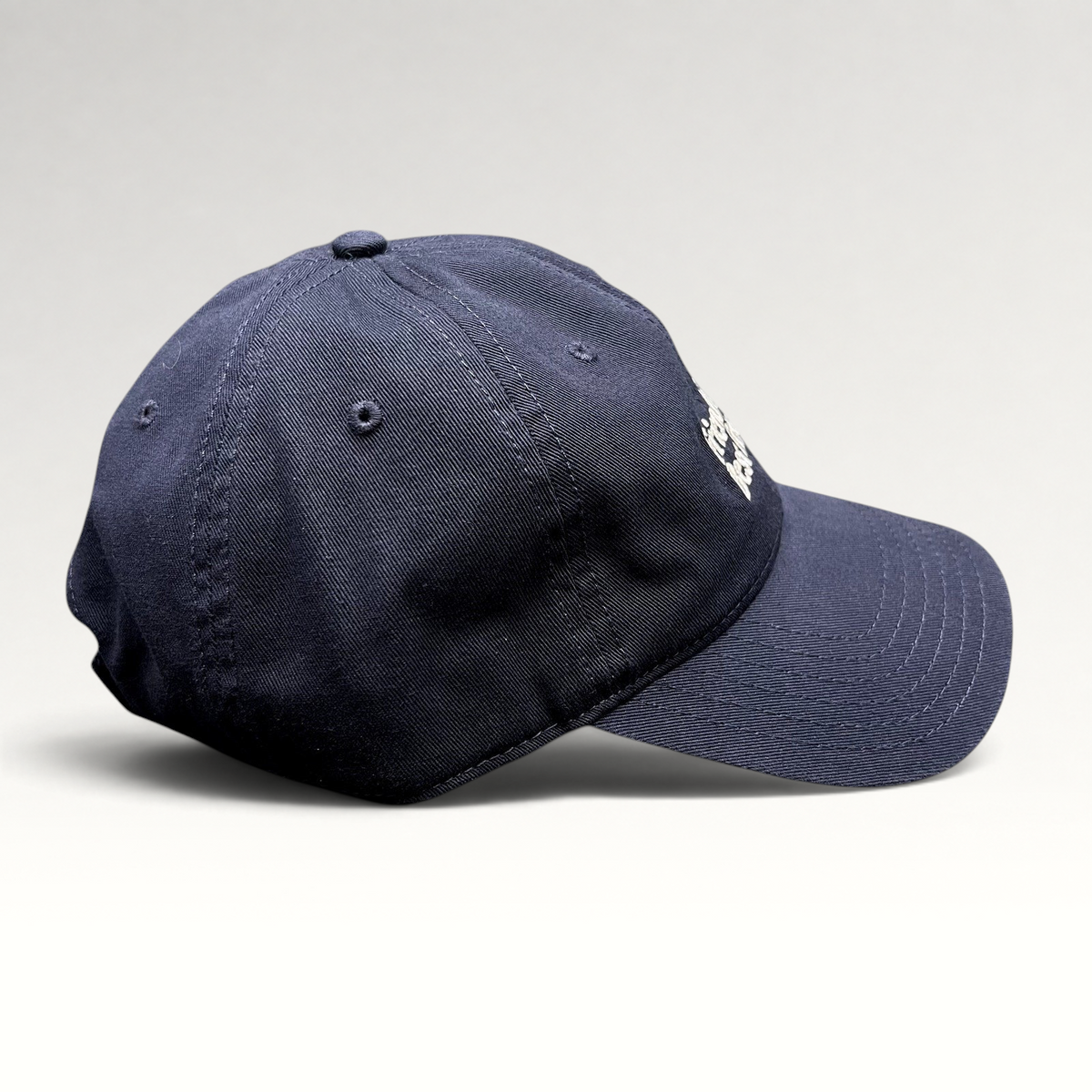 Raree Finds navy blue cotton twill dad hat with white embroidered text and a relaxed unstructured fit.