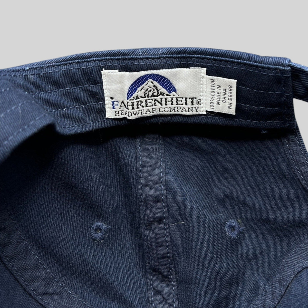 Raree Finds navy cotton dad hat interior showing Fahrenheit Headwear Company brand label and 100% cotton tag