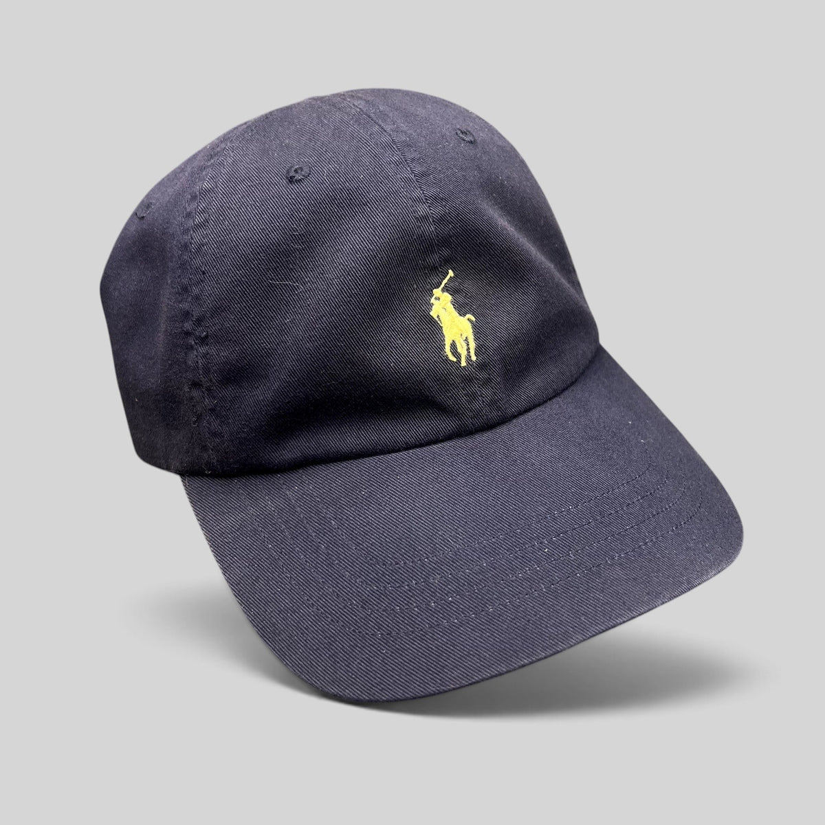 Raree Finds navy cotton chino baseball cap with yellow embroidered Polo Pony logo and adjustable strapback