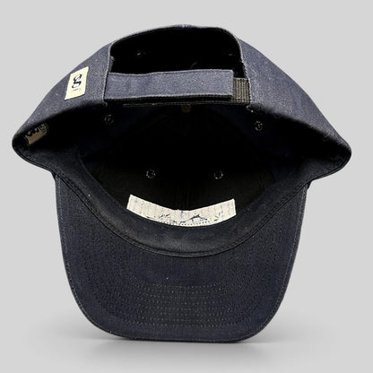 Raree Finds vintage navy blue cotton strapback hat showing the interior construction, adjustable strap, and branding.