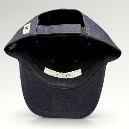 Raree Finds vintage navy blue cotton strapback hat showing the interior construction, adjustable strap, and branding.