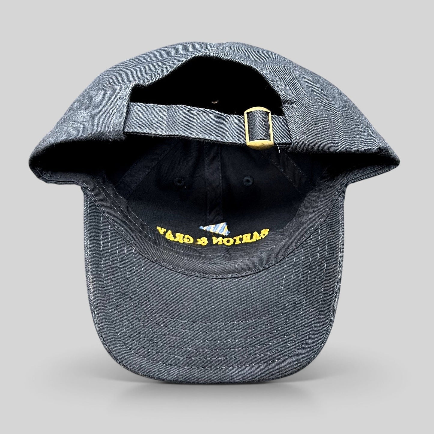 Raree Finds navy blue cotton strapback hat with adjustable brass buckle and embroidered logo detail
