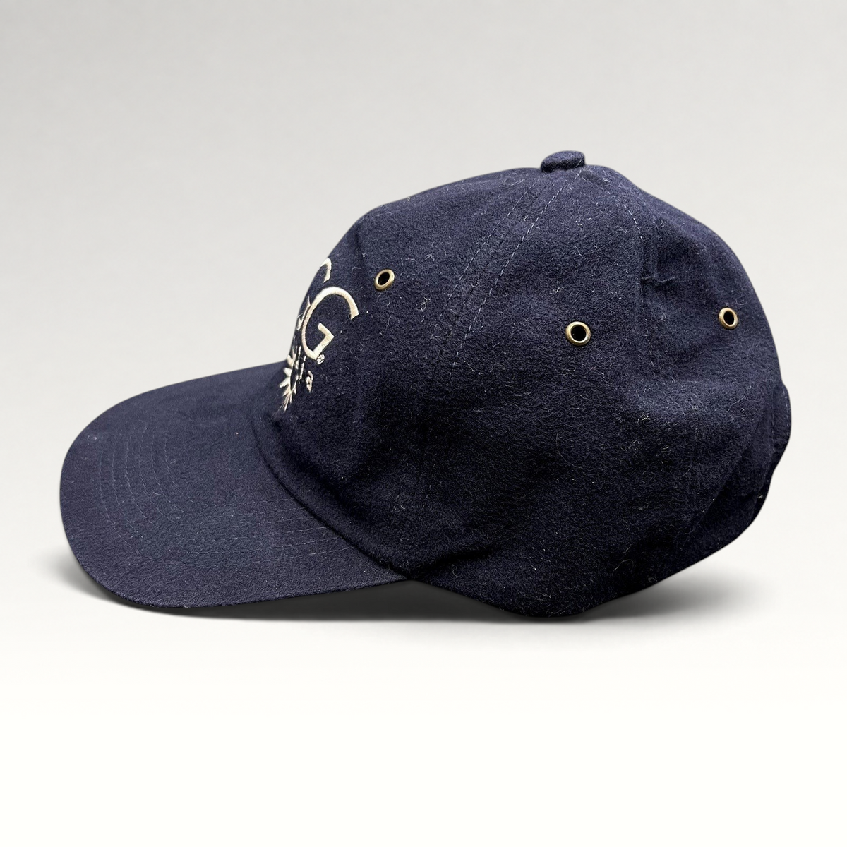 Raree Finds vintage navy blue cotton UGG Australia strapback hat with embroidered logo and brass eyelets