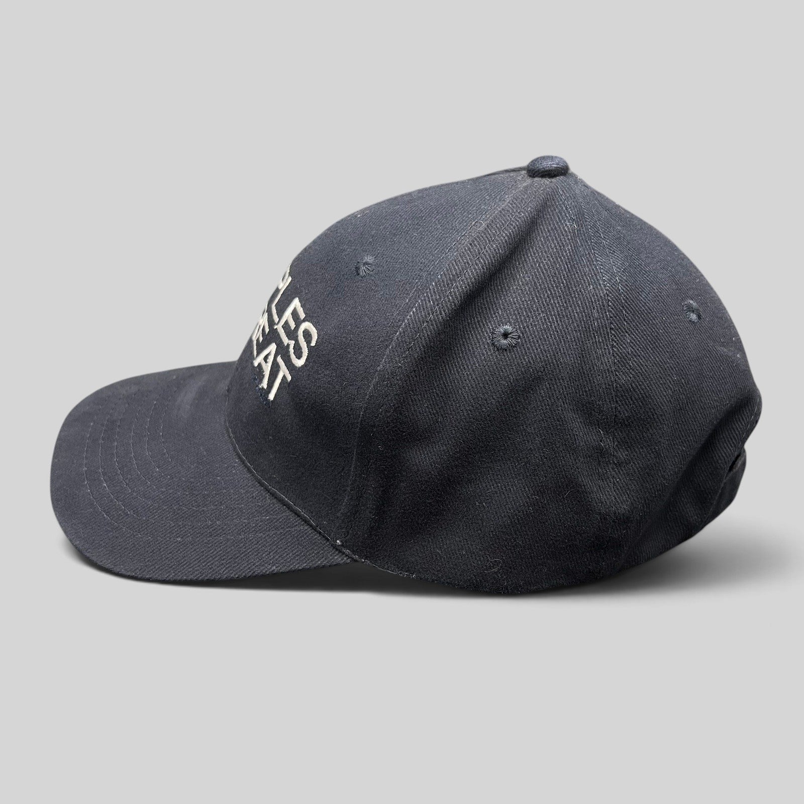 Raree Finds navy cotton strapback hat with white Couples Retreat film embroidery and unstructured crown profile