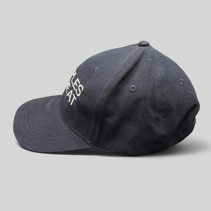 Raree Finds navy cotton strapback hat with white Couples Retreat film embroidery and unstructured crown profile