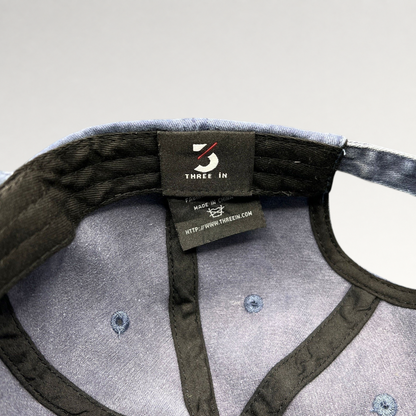 Raree Finds navy dad hat interior showing Three In brand label and stitching details