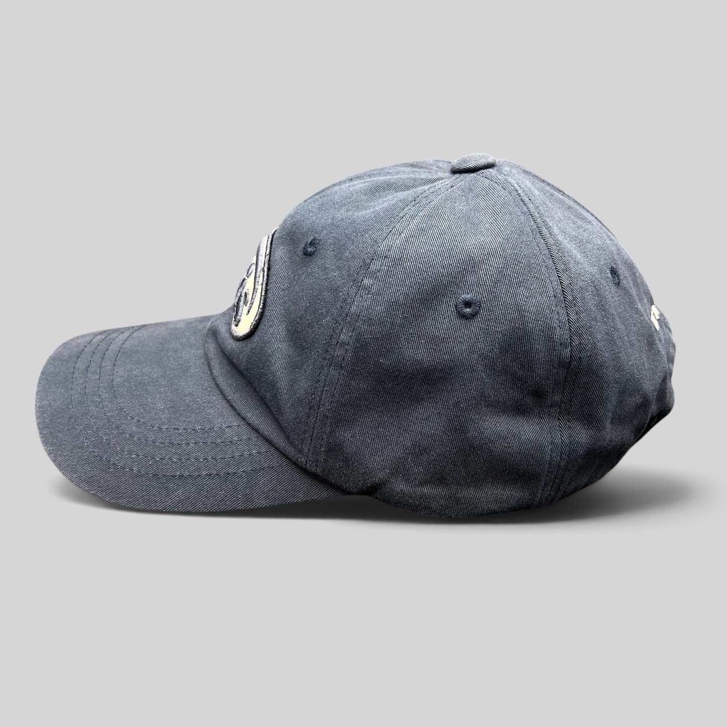 Raree Finds navy EMIS cotton strapback hat with a curved brim and minimalist oval logo embroidery on the side