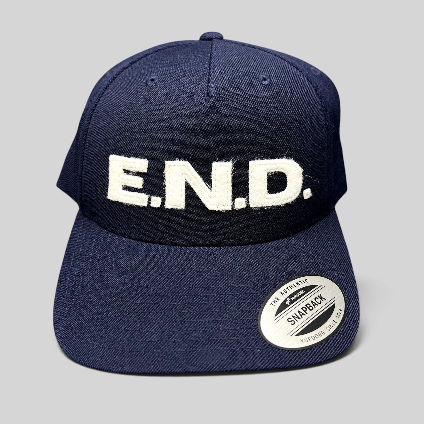 Raree Finds navy blue Yupoong Classics snapback hat with oversized white felt E.N.D. lettering on the front crown.