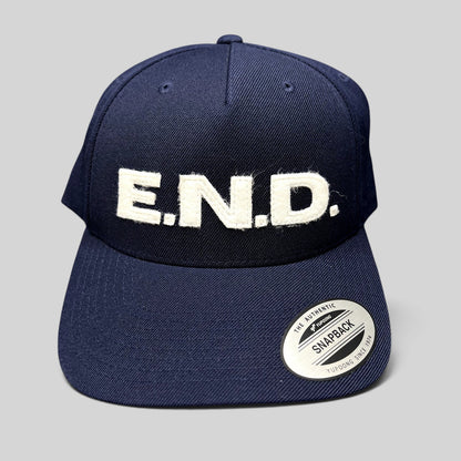Raree Finds navy blue Yupoong Classics snapback hat with oversized white felt E.N.D. lettering on the front crown.