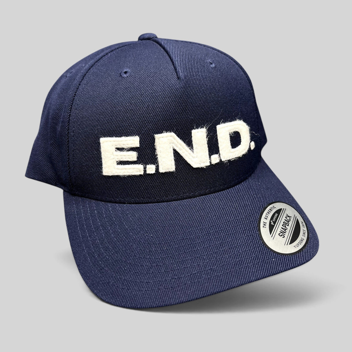 Raree Finds navy blue Yupoong Classics snapback hat with white felt E.N.D. lettering on the structured front crown.