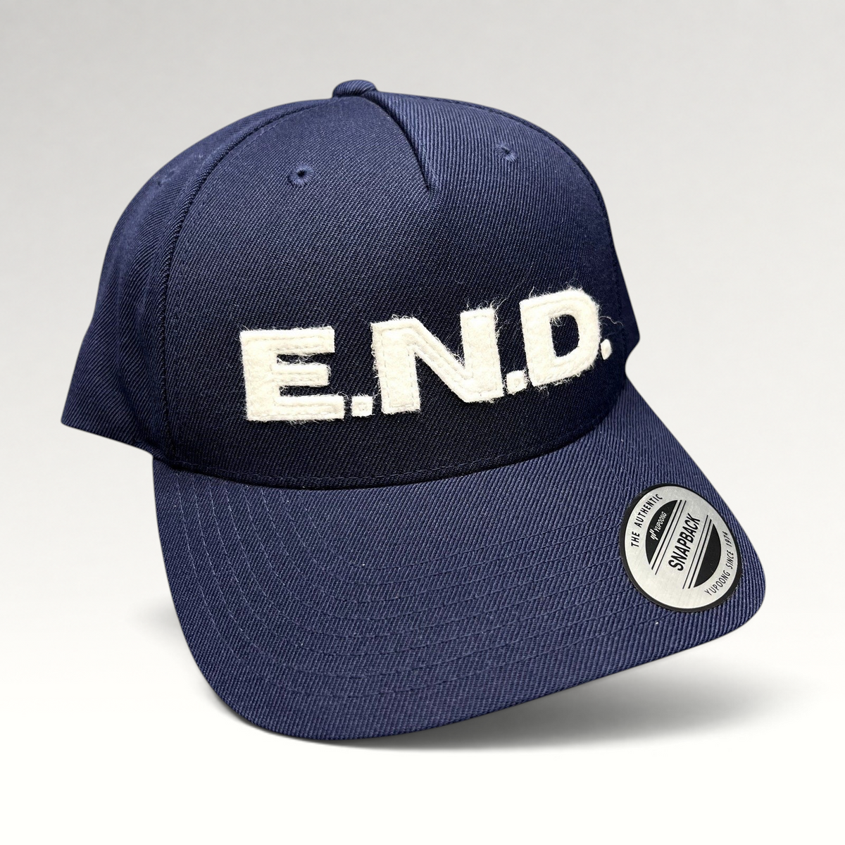 Raree Finds navy blue Yupoong Classics snapback hat with white felt E.N.D. lettering on the structured front crown.