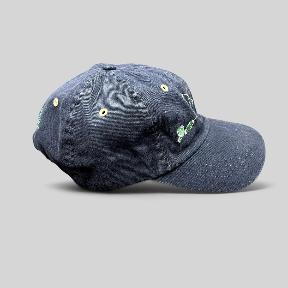 Raree Finds vintage navy cotton strapback hat with embroidered fly fishing lure design and metal eyelets