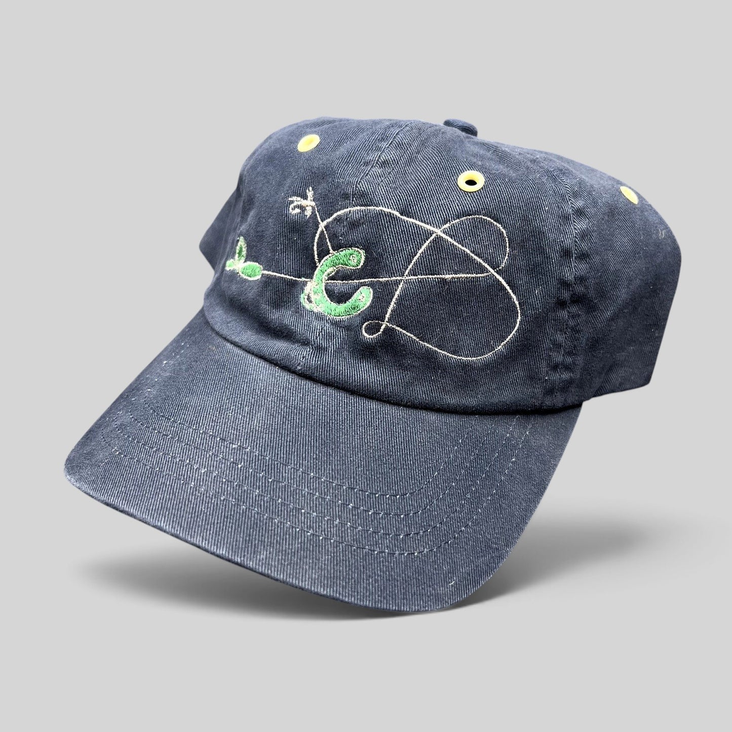 Raree Finds vintage navy cotton strapback hat with embroidered fly fishing lure design and yellow metal eyelets