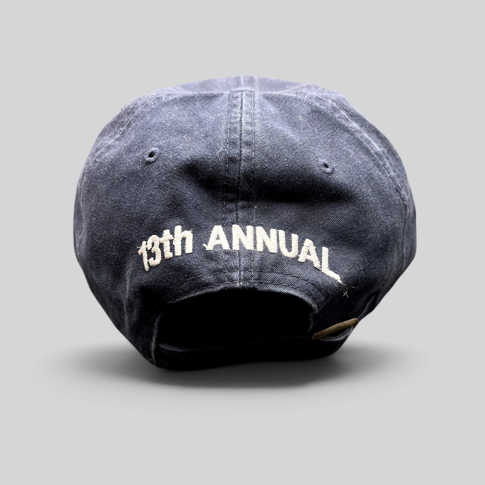 Raree Finds vintage navy blue golf hat with 13th Annual embroidered on the back and adjustable brass buckle strapback.
