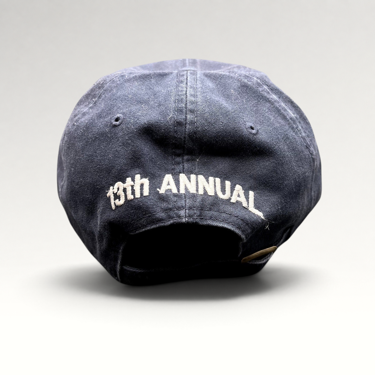 Raree Finds vintage navy blue golf hat with 13th Annual embroidered on the back and adjustable brass buckle strapback.