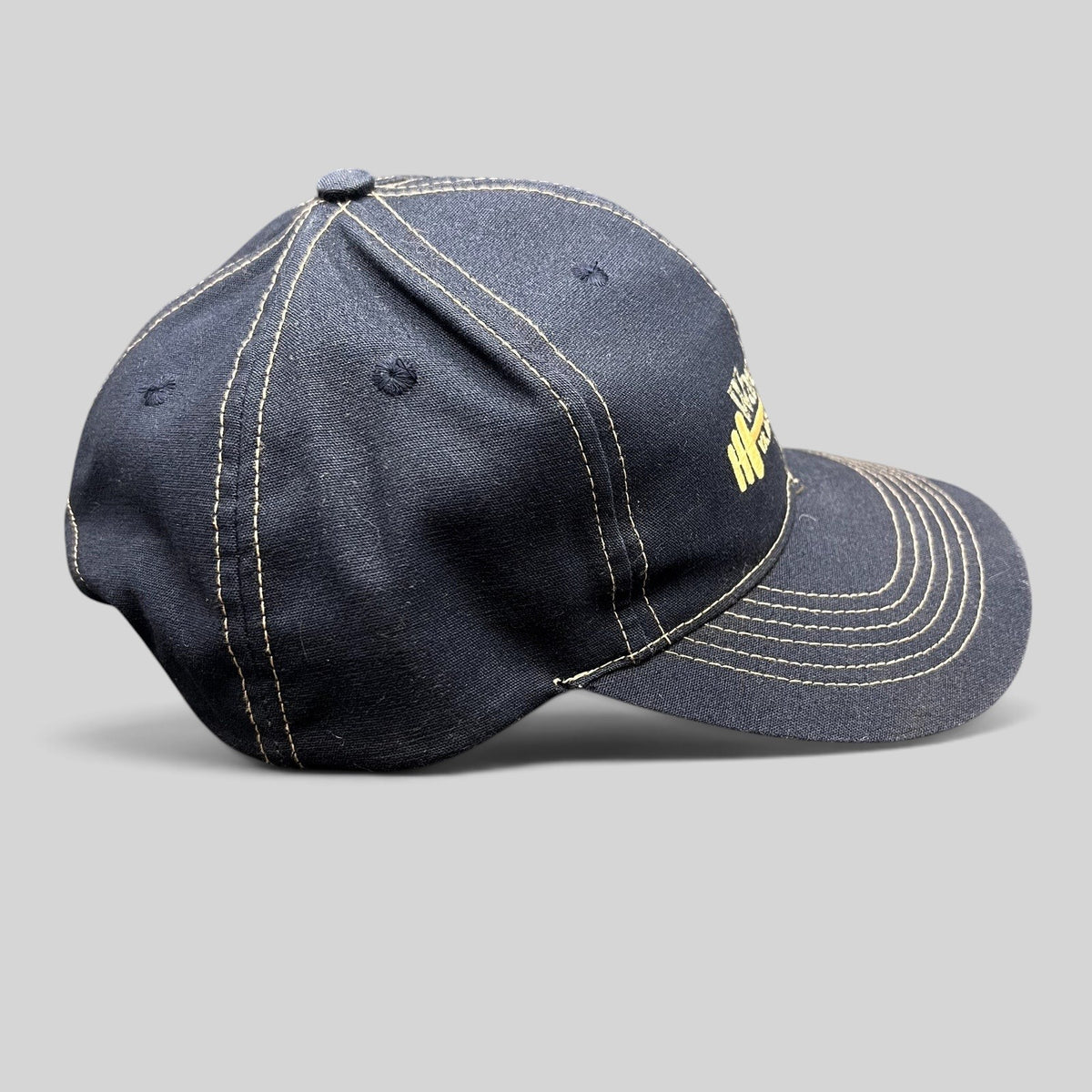 Raree Finds vintage navy blue snapback hat with gold contrast stitching and embroidered Wareing’s Gym barbell logo.