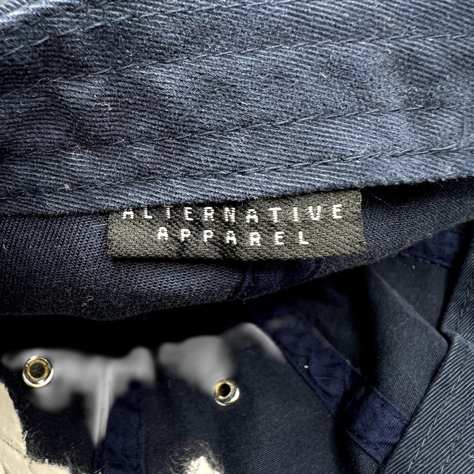 Raree Finds vintage navy cotton hat interior showing the Alternative Apparel brand tag and metal eyelets