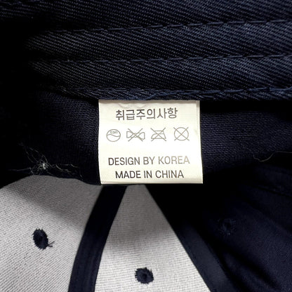 Raree Finds navy blue Readyverse Studios hat interior label showing care instructions and Design by Korea text