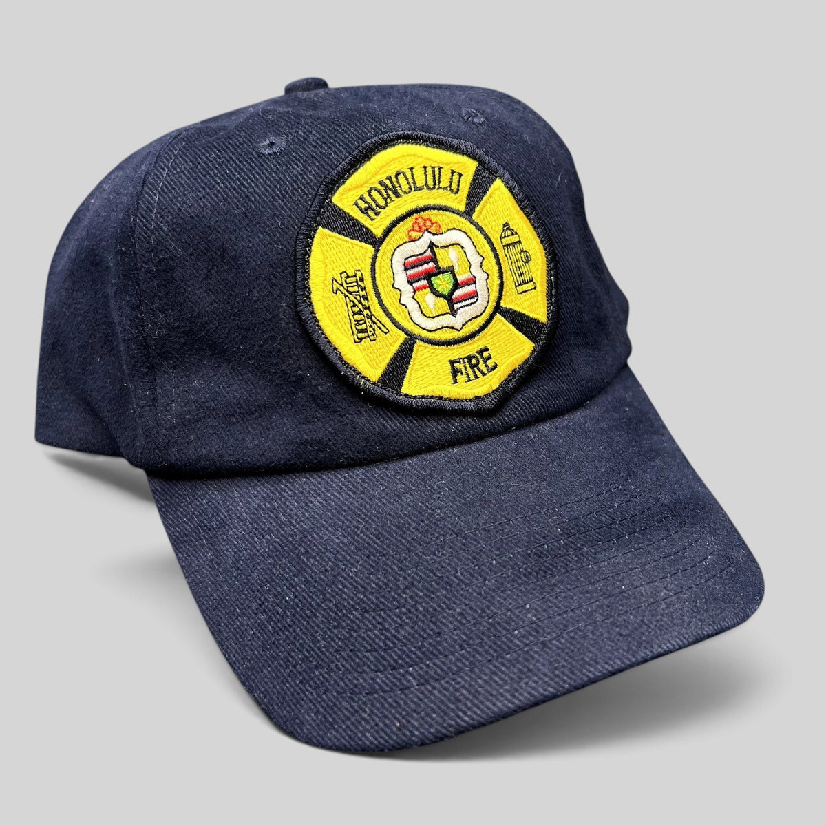 Raree Finds vintage navy blue cotton strapback hat with an embroidered Honolulu Fire Department maltese cross patch.