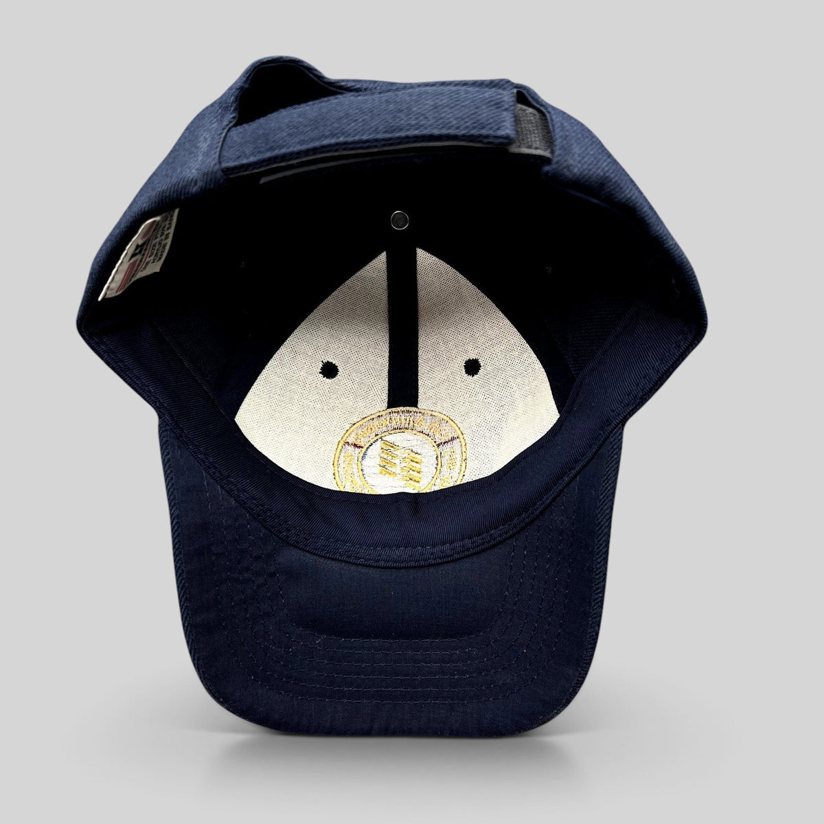 Raree Finds navy blue wool-blend strapback hat featuring an embroidered 75th anniversary LAWA seal on the interior