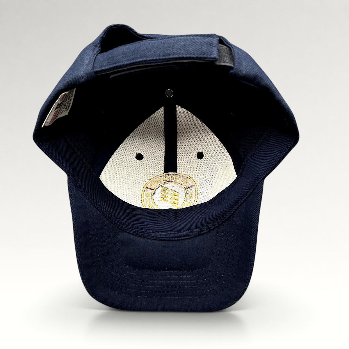Raree Finds navy blue wool-blend strapback hat featuring an embroidered 75th anniversary LAWA seal on the interior