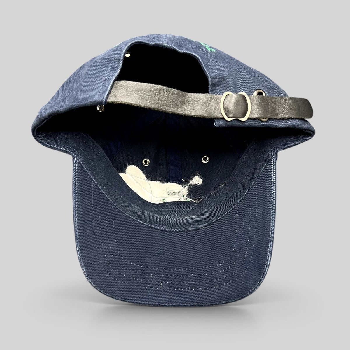 Raree Finds vintage navy cotton strapback hat with a black leather adjustable strap and metal buckle detail